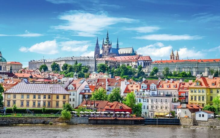 View of colorful old town and Prague castle with river